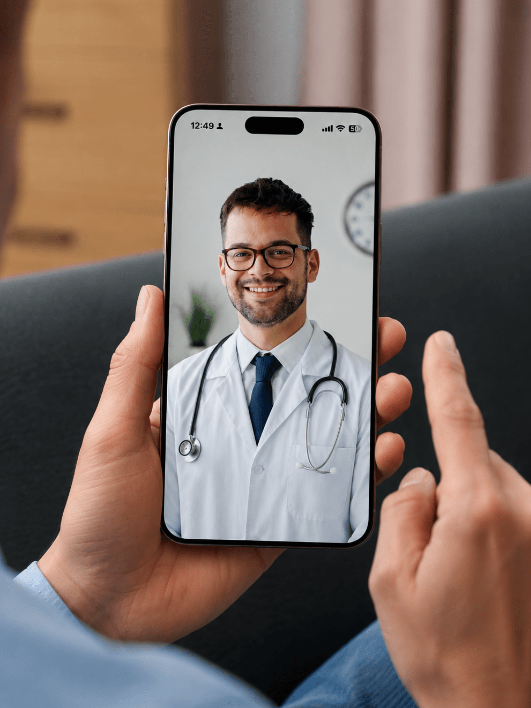 A physician talks with a patient during a secure video consultation.